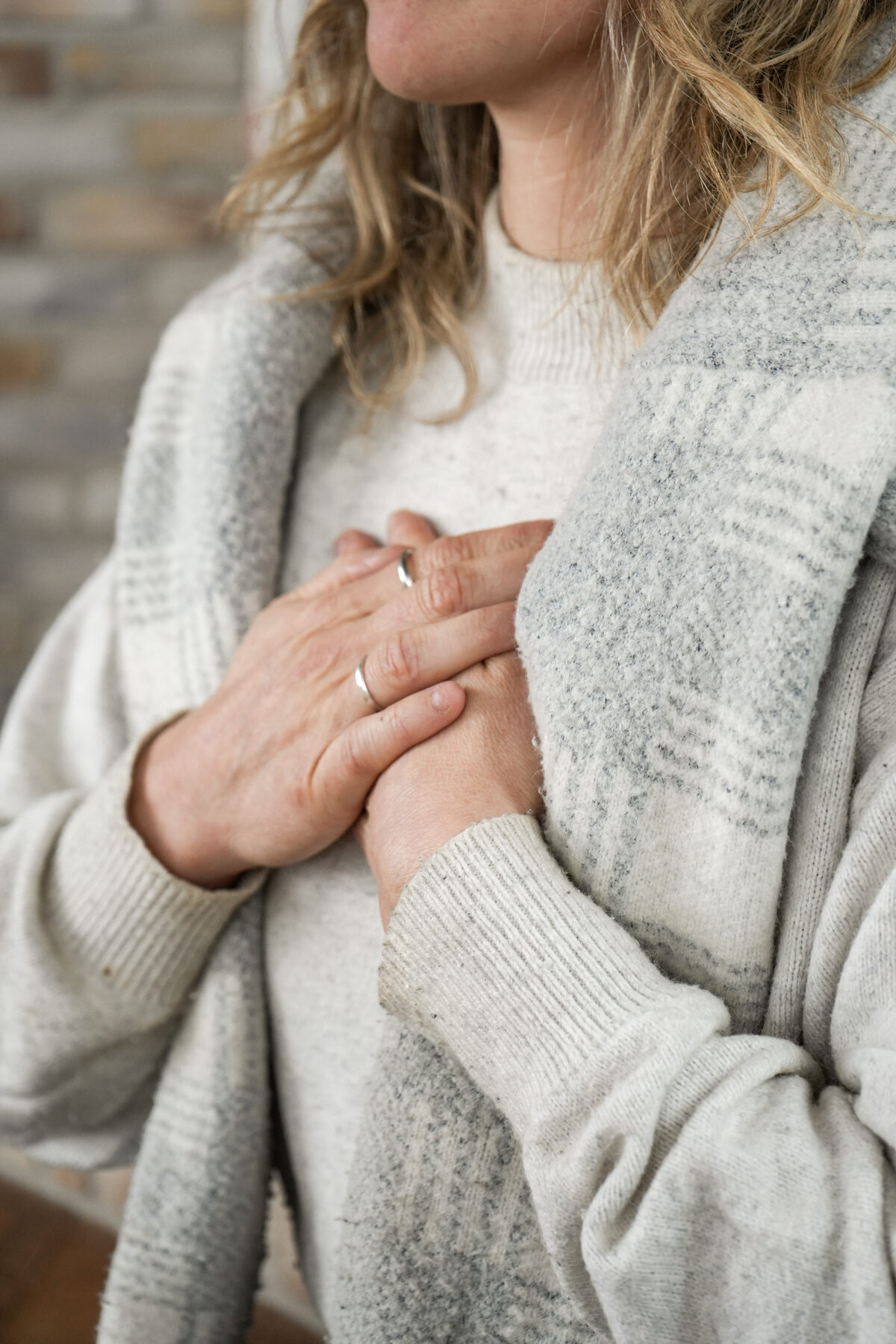 Une personne pose doucement ses mains croisées sur son cœur